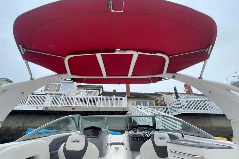 Slide: The Image of 2014 Chaparral 224 Sunesta boat with red canopy and modern interior design. - 41