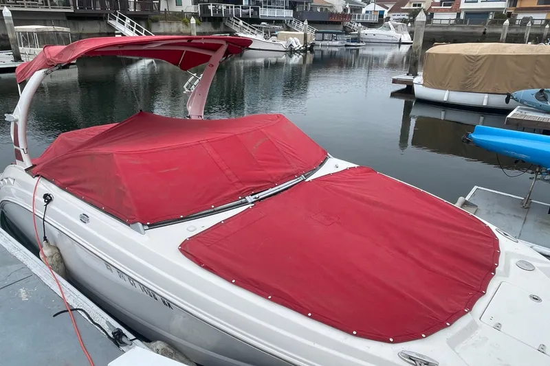 Slide: The Image of 2014 Chaparral 224 Sunesta boat with red cover docked in marina. - 42