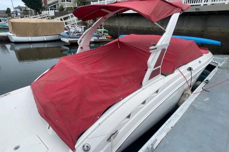 Slide: The Image of 2014 Chaparral 224 Sunesta boat with red cover docked in marina. - 43
