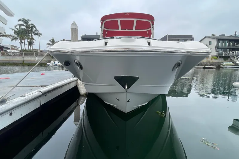 Slide: The Image of 2014 Chaparral 224 Sunesta boat docked in a marina, front view. - 7