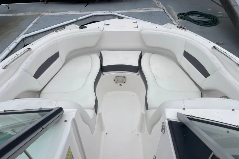 Slide: The Image of 2014 Chaparral 224 Sunesta boat interior with white cushioned seating. - 9