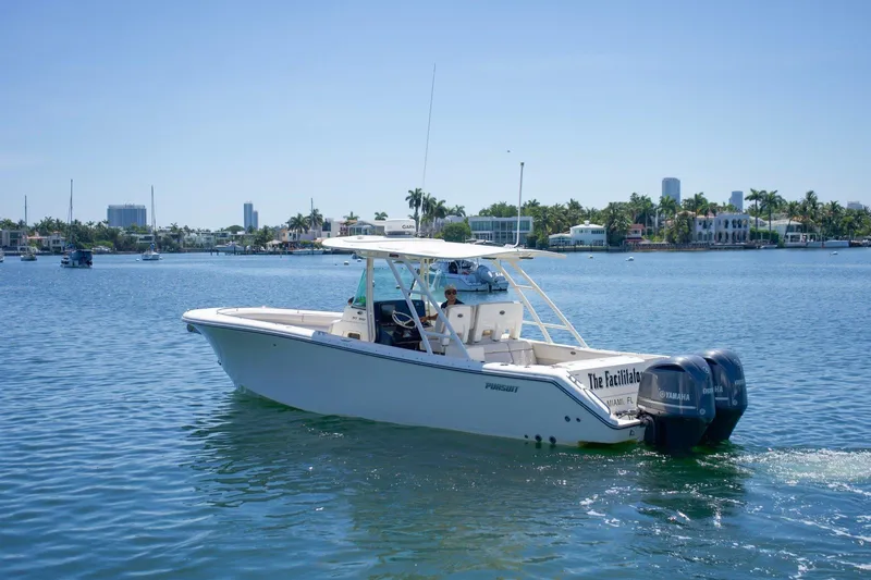 The Image of 2014 Pursuit ST 310 Sport boat cruising on a sunny day in Miami waters. - 0