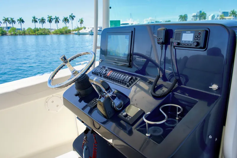 Slide: The Image of 2014 Pursuit ST 310 Sport helm with navigation equipment on open water. - 10