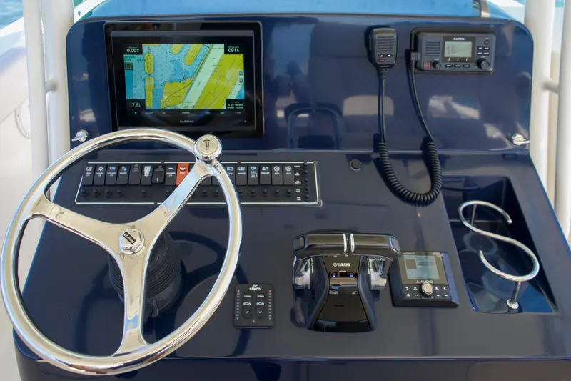 Slide: The Image of 2014 Pursuit ST 310 Sport helm with navigation system. - 11