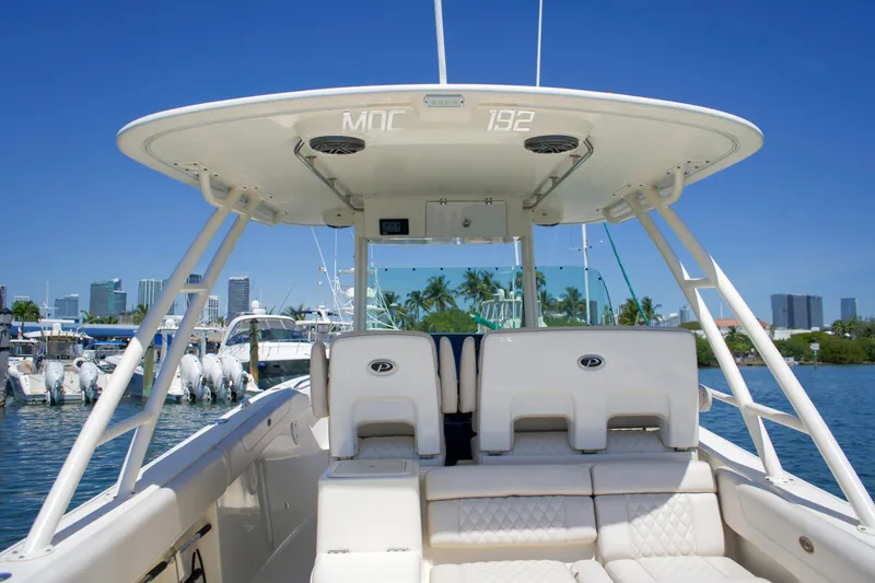 Slide: The Image of 2014 Pursuit ST 310 Sport boat docked with city skyline view. - 12