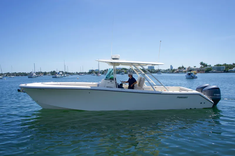 Slide: The Image of 2014 Pursuit ST 310 Sport boat on calm water. - 2