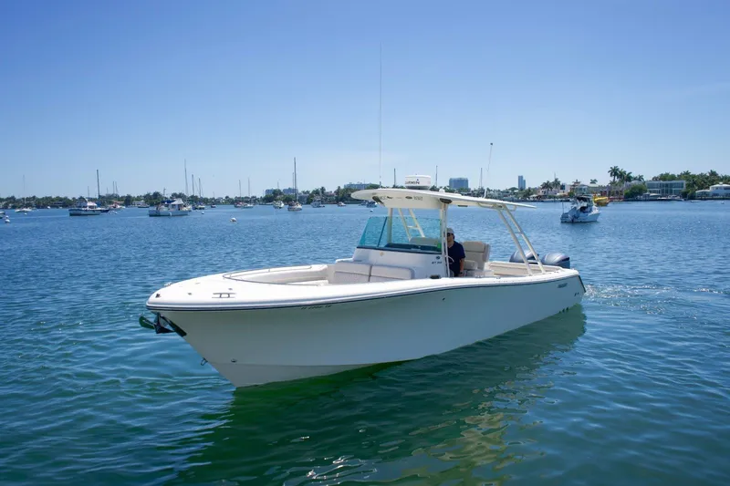 Slide: The Image of 2014 Pursuit ST 310 Sport boat cruising on a sunny day in a calm harbor. - 3