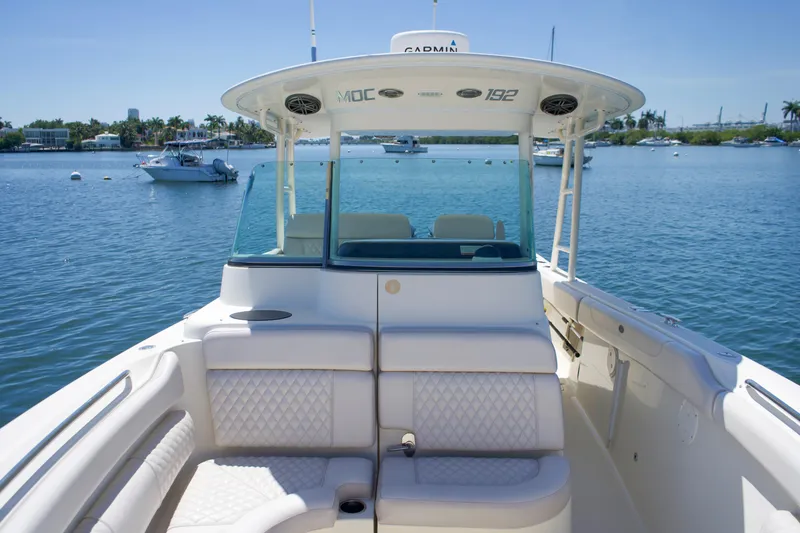 Slide: The Image of 2014 Pursuit ST 310 Sport boat on calm water. - 7