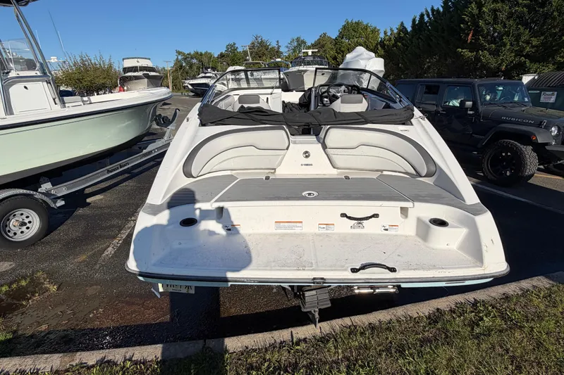 Slide: The Image of 2019 Yamaha Boats SX190 parked outdoors, showcasing rear deck and seating area. - 6