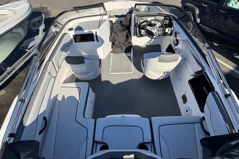 Slide: The Image of 2019 Yamaha Boats SX190 interior with seating and steering wheel, parked on trailer. - 7