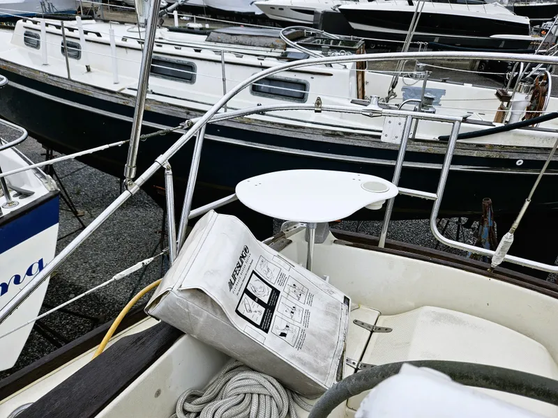 Slide: The Image of 1985 Sabre 34 sailboat in harbor with lifebuoy. - 4