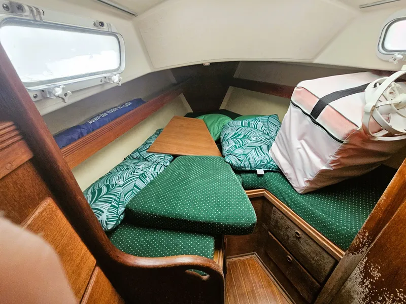 Slide: The Image of Interior of a 1985 Sabre 34 yacht with green cushions. - 7