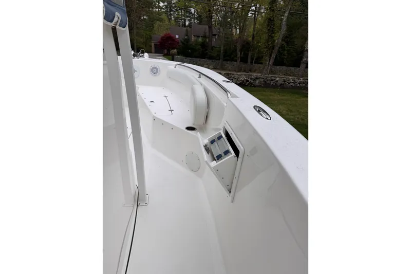 Slide: The Image of 2015 Tidewater 252 CC Adventure boat interior with sleek white design and seating area. - 22