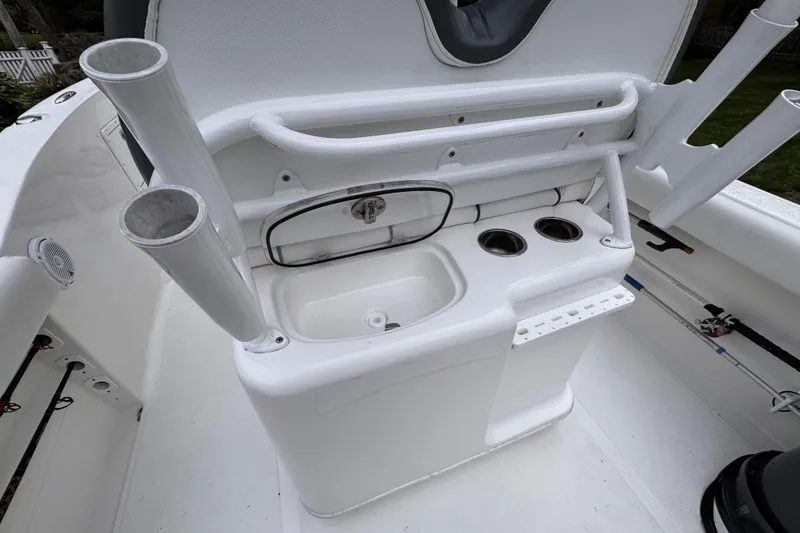 Slide: The Image of 2015 Tidewater 252 CC Adventure boat console with sink and rod holders. - 24