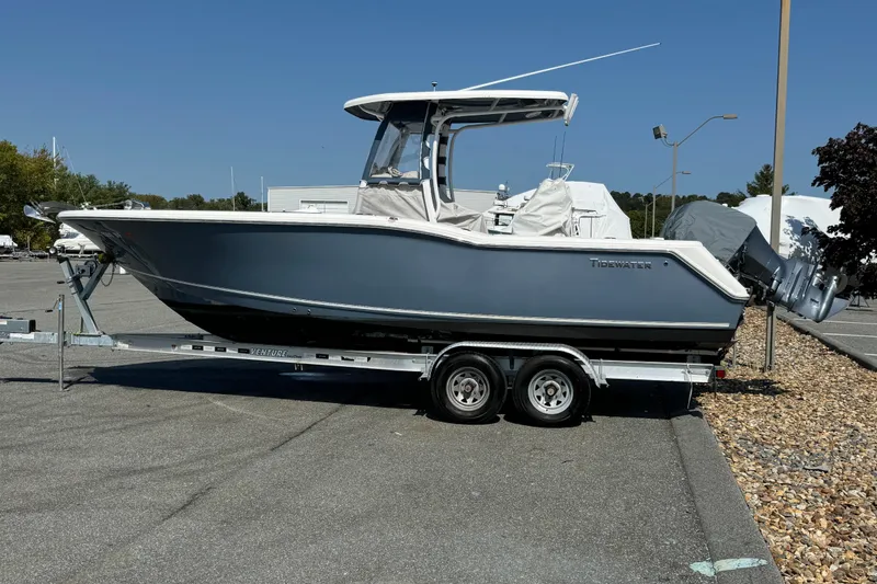 Slide: The Image of 2015 Tidewater 252 CC Adventure boat on trailer in parking lot, side view. - 4