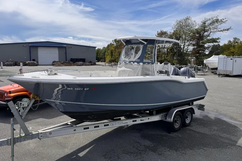 Slide: The Image of 2015 Tidewater 252 CC Adventure boat on trailer in outdoor setting. - 6