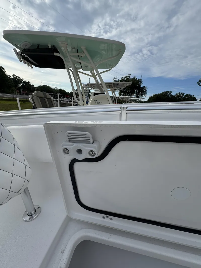 Slide: The Image of Sportsman Open 232 Center Console 2026 with open storage hatch. - 11