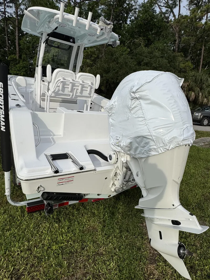 Slide: The Image of 2026 Sportsman Open 232 Center Console boat with covered outboard motor. - 7
