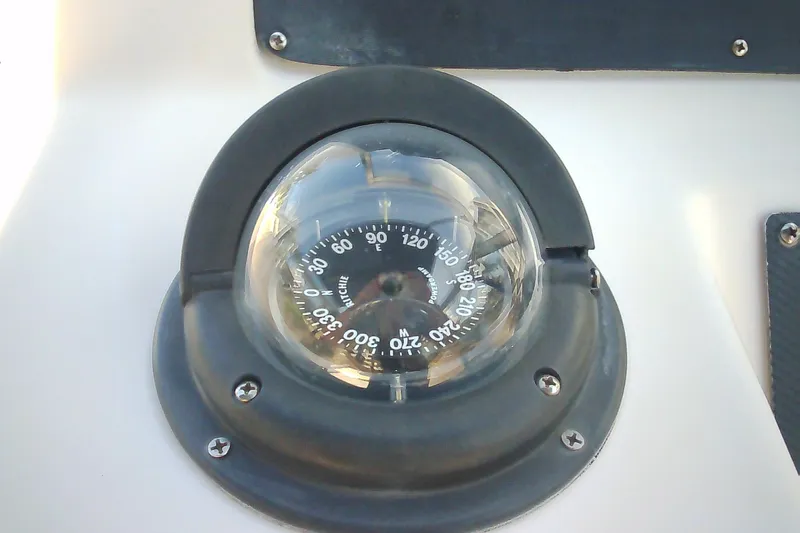 Slide: The Image of Compass on 2005 Grady-White Tournament 225 boat dashboard, displaying navigational directions. - 15