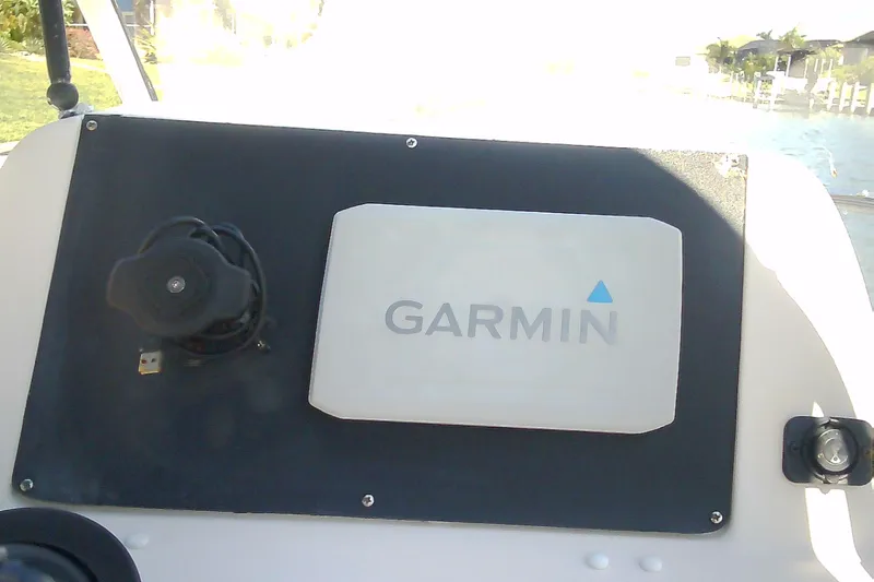 Slide: The Image of Garmin device on 2005 Grady-White Tournament 225 boat dashboard, near waterway. - 16