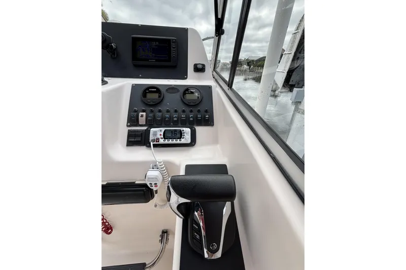 Slide: The Image of 2005 Grady-White Tournament 225 boat dashboard with controls and navigation equipment. - 2