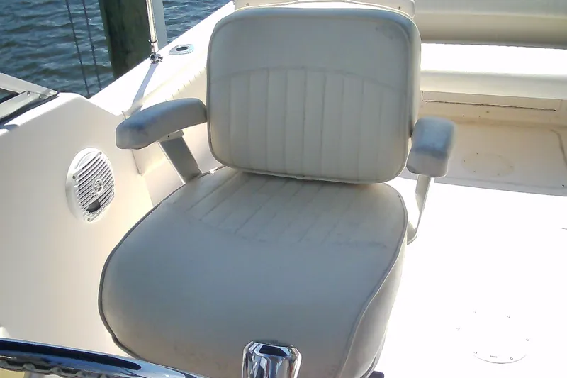 Slide: The Image of Captain's chair on a 2005 Grady-White Tournament 225 boat, near water. - 21