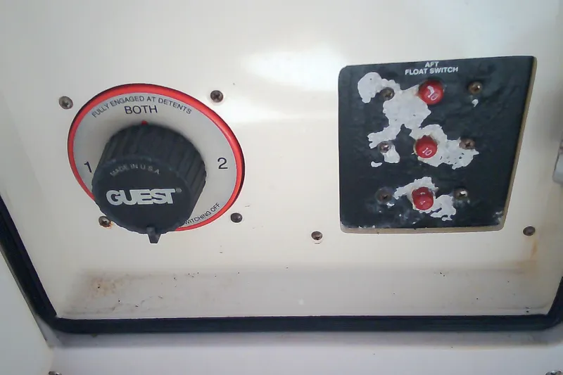 Slide: The Image of Control panel of a 2005 Grady-White Tournament 225 boat with switches and dials. - 24