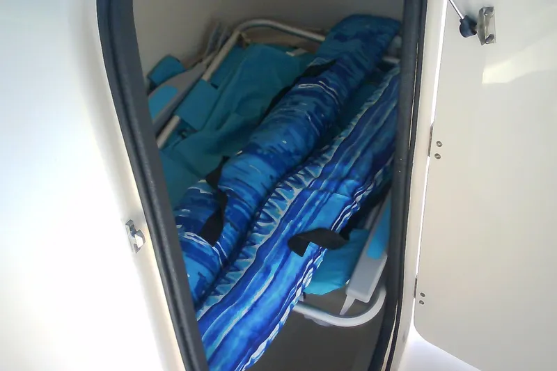 Slide: The Image of Storage compartment in a 2005 Grady-White Tournament 225 boat with blue gear. - 26