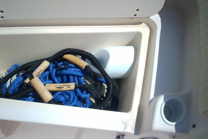 Slide: The Image of Storage compartment with ropes on a 2005 Grady-White Tournament 225 boat. - 28