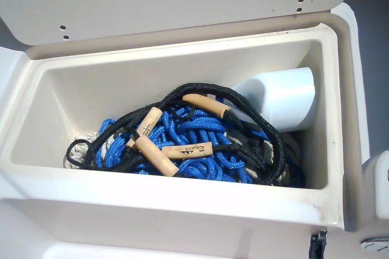 Slide: The Image of Storage compartment on a 2005 Grady-White Tournament 225 boat with ropes and accessories. - 29
