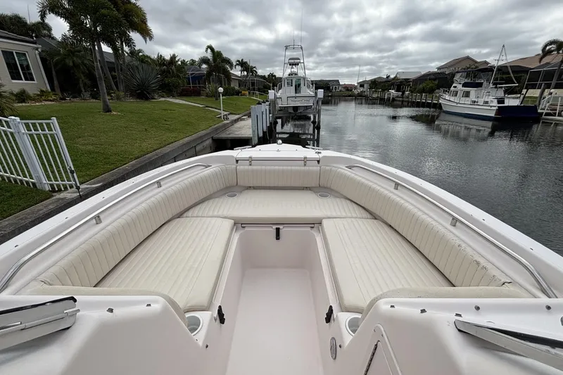 Slide: The Image of 2005 Grady-White Tournament 225 boat docked in a serene canal setting. - 3