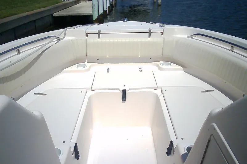 Slide: The Image of 2005 Grady-White Tournament 225 boat interior with white seating and storage compartments. - 30
