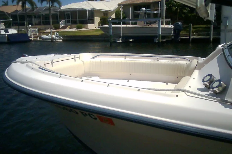Slide: The Image of 2005 Grady-White Tournament 225 boat docked near waterfront homes. - 33