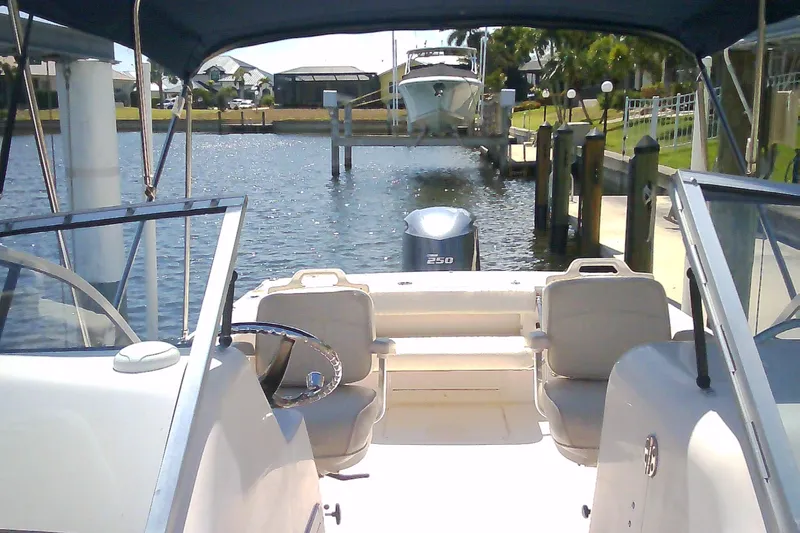 Slide: The Image of 2005 Grady-White Tournament 225 boat docked in a sunny marina setting. - 7