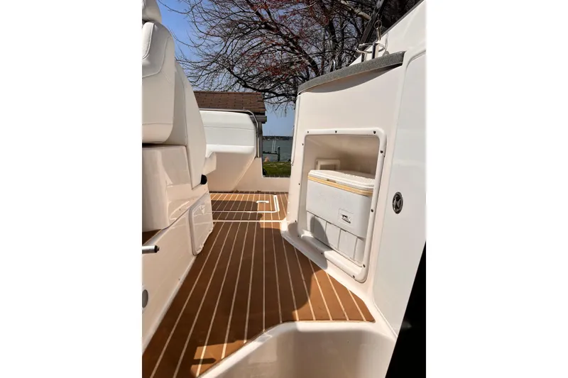 Slide: The Image of 2006 Regal Commodore 2665 boat interior with wooden flooring and built-in cooler. - 13