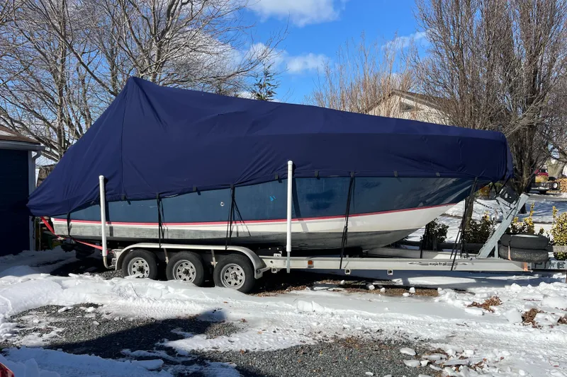 Slide: The Image of 2006 Regal Commodore 2665 boat covered on trailer in snowy driveway. - 15