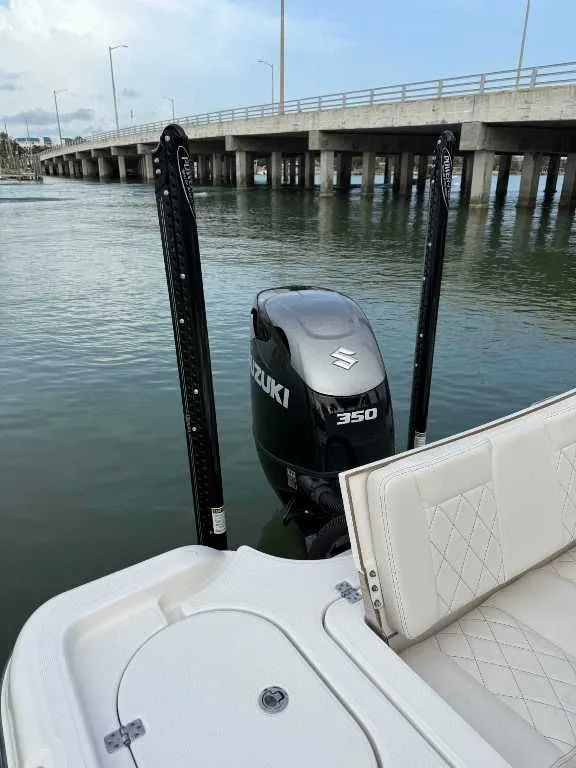 Slide: The Image of Blue Wave 2800 Makaira boat with Suzuki 350 engine, bridge in background. - 6