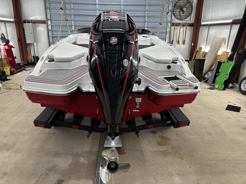 Slide: The Image of 2026 Tahoe S 210 S boat with outboard motor in garage. - 10