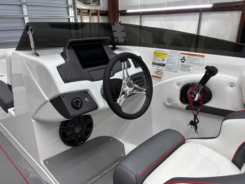 Slide: The Image of Interior of 2026 Tahoe S 210 S boat with steering console. - 14