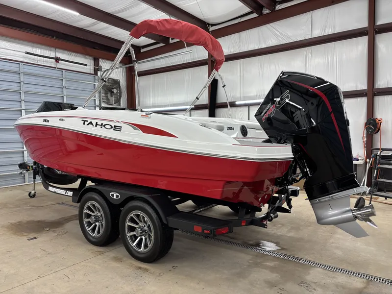 Slide: The Image of 2026 Tahoe S 210 S boat in red color inside a garage. - 4