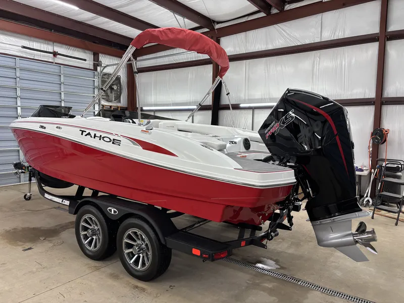 Slide: The Image of 2026 Tahoe S 210 S boat in red and white finish inside a garage. - 5