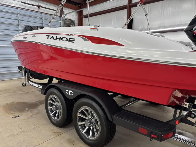 Slide: The Image of Red 2026 Tahoe S 210 S boat on trailer in garage. - 6