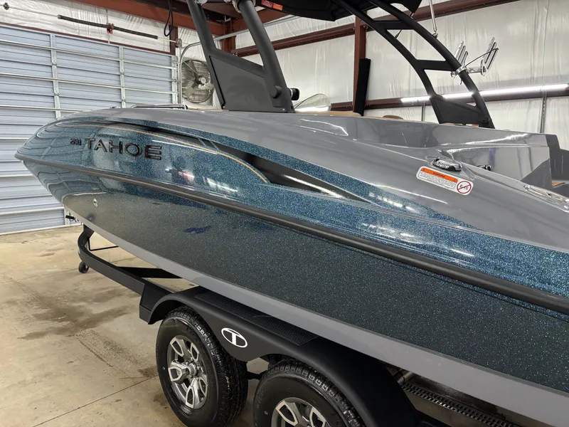 Slide: The Image of 2026 Tahoe Deck 2150 boat in a storage facility. - 10