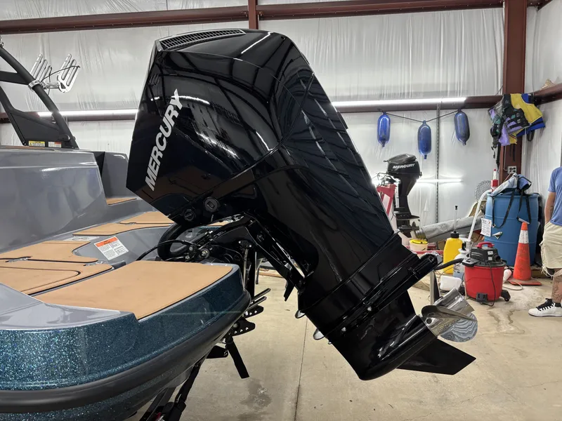 Slide: The Image of 2026 Tahoe Deck 2150 with Mercury outboard motor in workshop. - 12