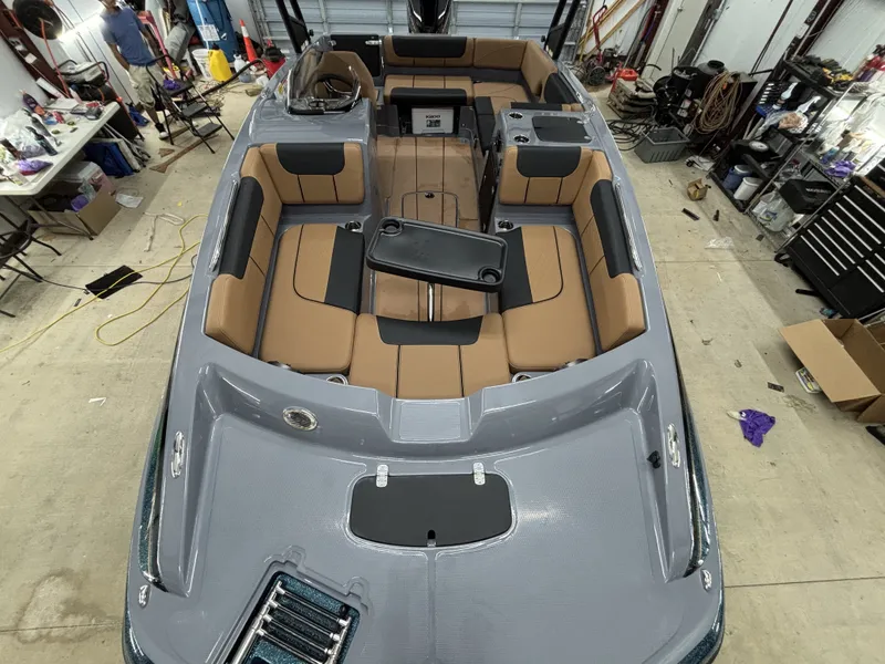 Slide: The Image of Interior view of 2026 Tahoe Deck 2150 boat in a workshop. - 13