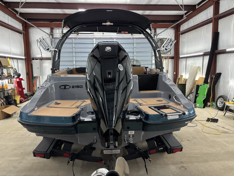 Slide: The Image of 2026 Tahoe Deck 2150 boat in a workshop. - 14
