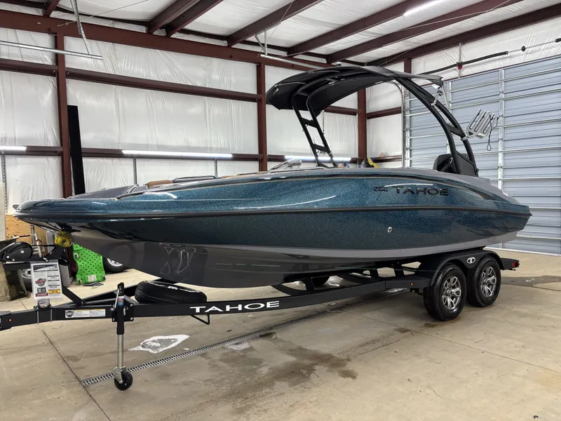 Slide: The Image of 2026 Tahoe Deck 2150 boat in warehouse on trailer. - 2