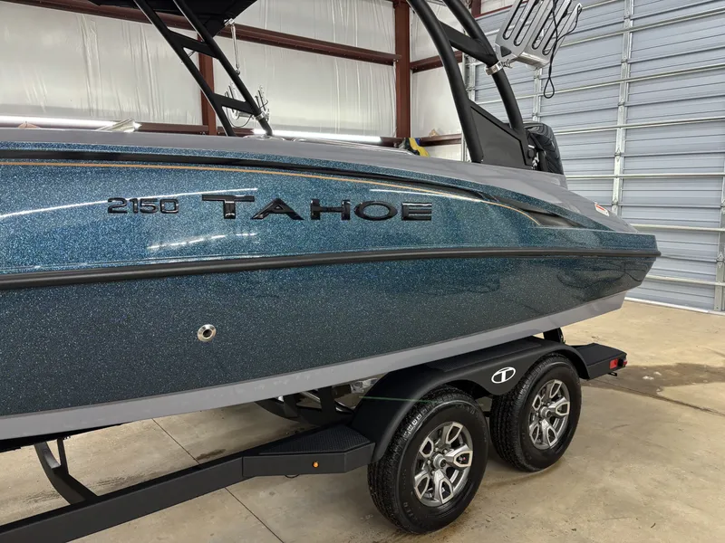 Slide: The Image of 2026 Tahoe Deck 2150 boat in a garage on a trailer. - 3