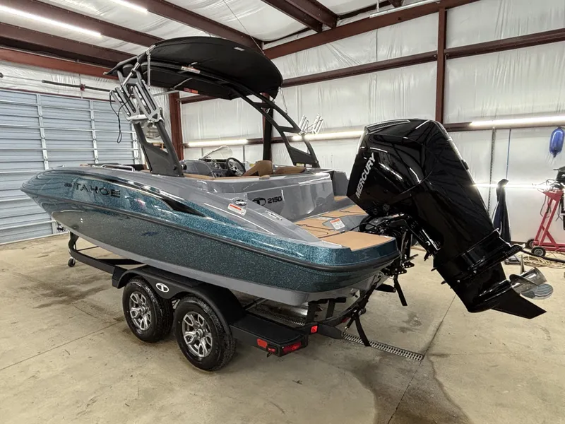 Slide: The Image of 2026 Tahoe Deck 2150 boat in warehouse with trailer. - 8