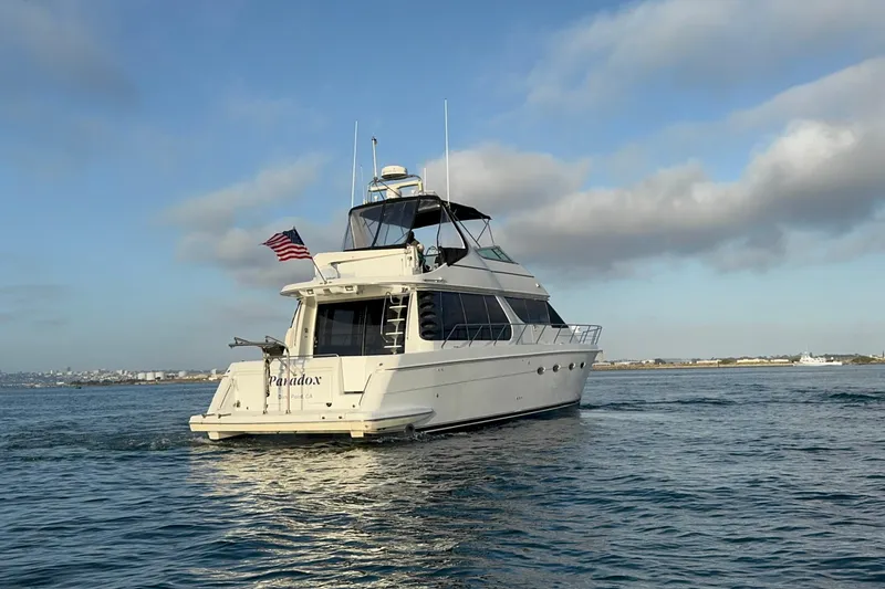 Slide: The Image of 2000 Carver 530 Voyager Pilothouse yacht cruising on open water under a clear sky. - 10